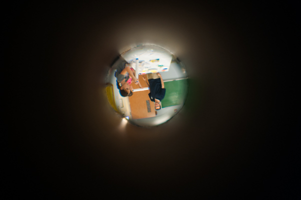 The camera peeks through a student's telescope.