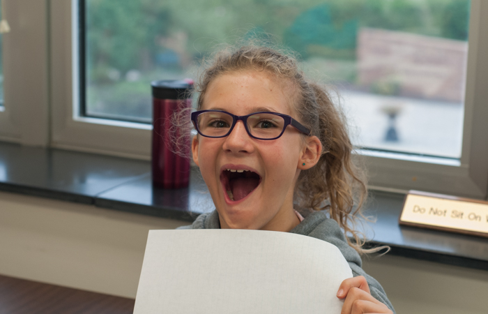 A student gets excited to share her work.