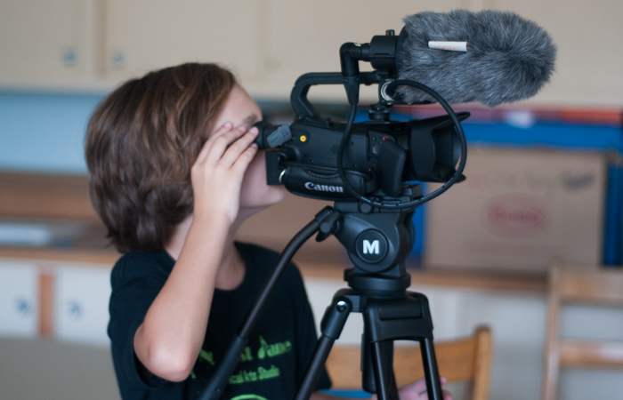 A student filming a scene.