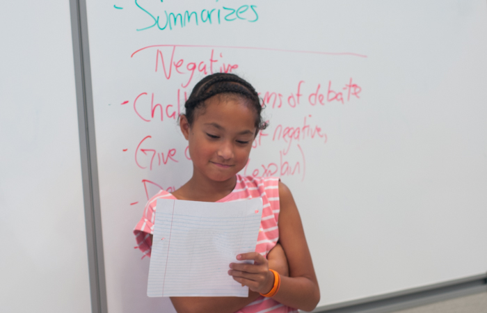  A student prepares to deliver her speech.